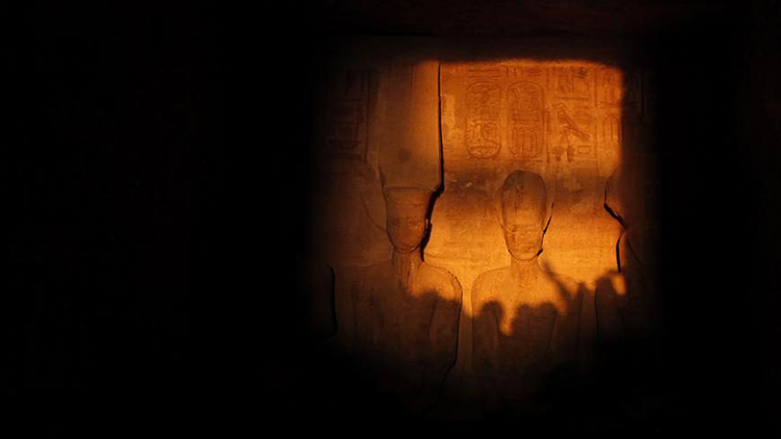 The light of dawn shines on the statues of Pharaoh Ramses II (R) and Amun, the God of Light (L), in the inner sanctum of the temple of Abu Simbel, located at the upper reaches of the Nile in Aswan, around 1264 km (785 miles) south of Cairo February 22, 2014. The axis of the temple was designed so as to allow the rays of the sun to shine into the inner sanctuary only on Ramses II's birthday and his coronation. A militant Islamist group has warned tourists to leaveEgypt and threatened to attack any who stay a