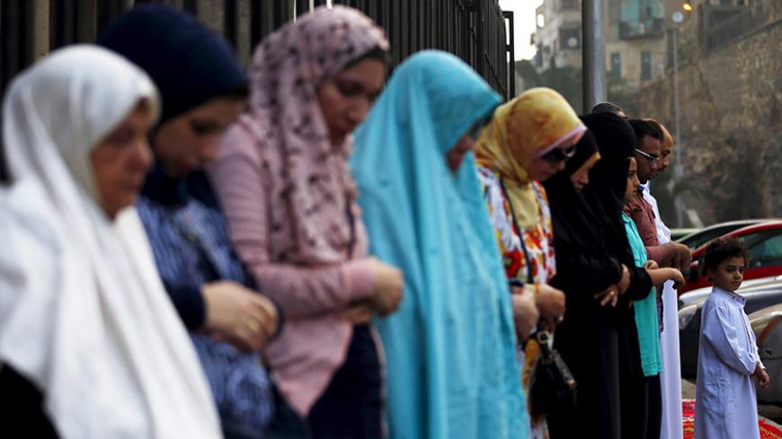 Egyptian Muslims perform Eid-al-Fitr prayers in front of Al Sultan Hassan and Al-Refaie mosques in the old Islamic area of Cairo, Egypt, July 17, 2015. Eid-al-Fitr marks the end of the Muslim fasting month of Ramadan, the holiest month in the Islamic calendar. REUTERS/Amr Abdallah Dalsh - RTX1KMW6