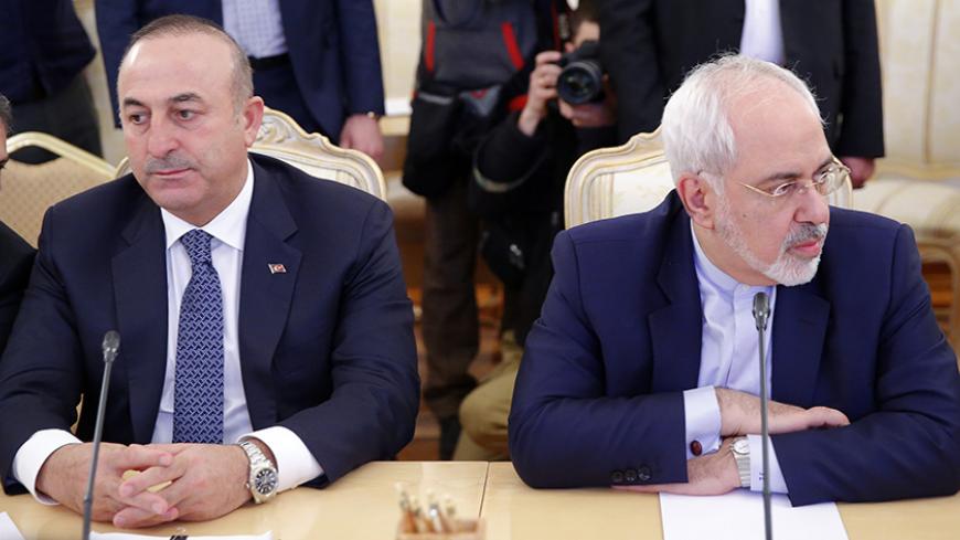 Foreign ministers, Mevlut Cavusoglu (2nd L) of Turkey and Mohammad Javad Zarif (R) of Iran, attend a meeting in Moscow, Russia, December 20, 2016. REUTERS/Maxim Shemetov - RTX2VUBT