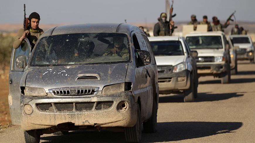 Rebel fighters ride in a convoy on the outskirts of the Islamic State-controlled northern Syrian town of al-Bab, Syria February 3, 2017. REUTERS/Khalil Ashawi - RTX2ZJJ9