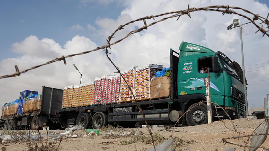 A truck loaded with goods enters the Gaza Strip from Israel through the Kerem Shalom crossing on October 12, 2014, in Rafah in southern Gaza. Some 50 countries are attending a Gaza Donor Conference in Egypt, with Palestinians hoping for $4 billion in global pledges, despite wariness from donors that without a full peace treaty with Israel they may just be pouring money down the drain. AFP PHOTO / SAID KHATIB (Photo credit should read SAID KHATIB/AFP/Getty Images)