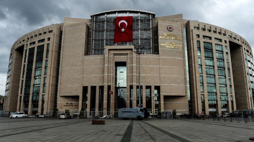 A photo taken on July 20, 2016 shows a Turkish flag on the Istanbul Justice Palace (Adalet Sarayi).
Turkish President Recep Tayyip Erdogan on July 20 chaired a crunch security meeting for the first time since the failed coup, as global alarm grew over a widening purge that has seen around 50,000 people either detained or sacked. / AFP / BULENT KILIC (Photo credit should read BULENT KILIC/AFP/Getty Images)