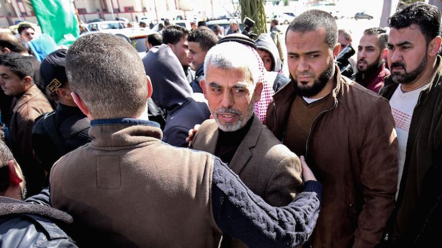 Yahya Sinwar (C), the new leader of Hamas in the Gaza Strip, arrives for the opening of a new mosque in Rafah town in the southern Gaza Strip on February 24, 2017. / AFP / SAID KHATIB        (Photo credit should read SAID KHATIB/AFP/Getty Images)