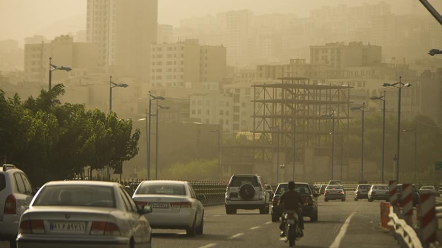 EDITORS' NOTE: Reuters and other foreign media are subject to Iranian restrictions on their ability to film or take pictures in Tehran.
Motorists travel on a highway in Tehran as the city is covered in dust July 6, 2009. The government closed private educational centres, state offices, industrial units and military bases for two days and raised its pollution alert status due to the dust, which an official from Tehran's environment office attributed the source to dust from dried marshland in Iraq blown towar