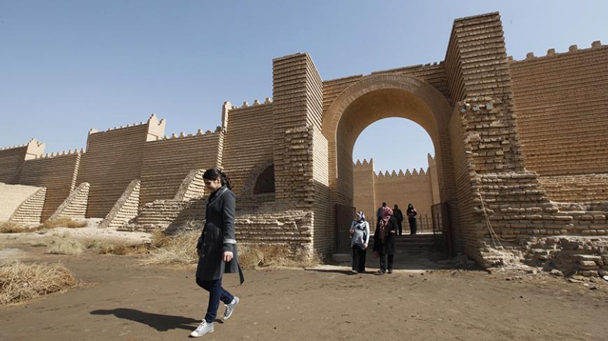 Residents visit the ancient city of Babylon near Hilla, 100 km (62 miles) south of Baghdad February 17, 2012. Picture taken February 17, 2012. REUTERS/Mohammed Ameen (IRAQ - Tags: TRAVEL SOCIETY) - RTR2Y1RF