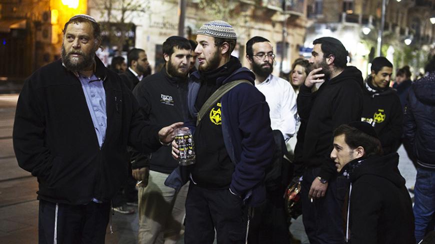 Benzion Gopshtein (L), leader of the far-right Israeli group Lehava, gathers with fellow activists in Jerusalem December 25, 2014. A far-right Israeli group that agitates against Arabs in the name of religion and national security is forcing the Jewish state into a legal and political balancing act as it tries to contain sectarian violence. The authorities are under pressure to deal with anyone encouraging Jewish retaliation against Israeli Arabs and Palestinians. Efforts to tackle Lehava, however, may be
