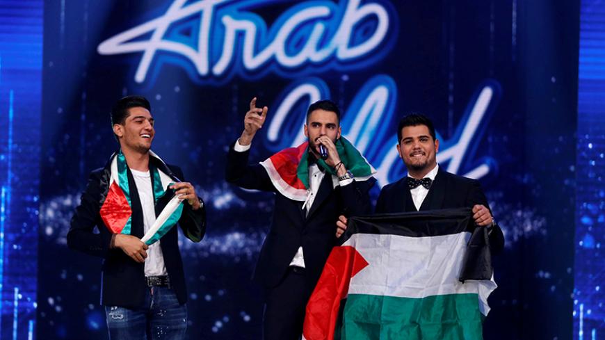Palestinian singer Yaqoub Shaheen (C), winner of Arab Idol season 4, performs as he stands next to Palestinian contestant singer Ameer Dandan (R) and Palestinian singer Mohammed Assaf, winner of the second season of Arab Idol, during the final episode of Arab Idol season 4, in Zouk Mosbeh area, north of Beirut, Lebanon February 25, 2017. REUTERS/Mohamed Azakir - RTS10BP3