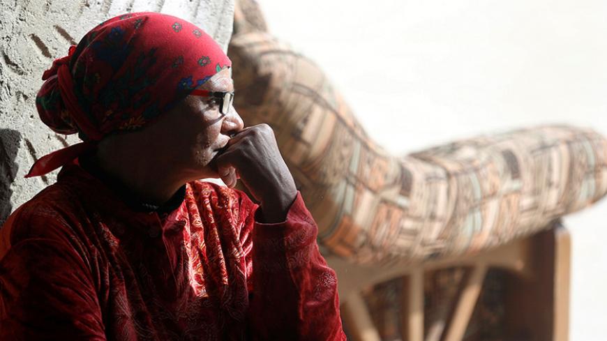 A Christian woman who left Al-Arish city, North Sinaiís Governorate capital, with her families after the escalation of a campaign targeting Christians by Islamic State militants, takes a rest after arriving at the Saint Church in Ismailia, northeast of Cairo, Egypt February 27, 2017. Picture taken February 27, 2017. REUTERS/Amr Abdallah Dalsh - RTS11695