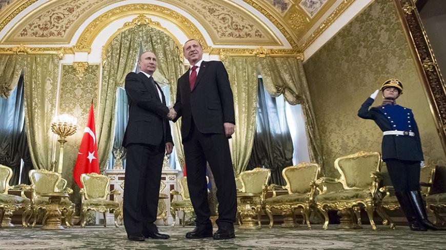 Russian President Vladimir Putin (L) shakes hands with his Turkish counterpart Tayyip Erdogan during a meeting at the Kremlin in Moscow, Russia, March 10, 2017. REUTERS/Zemlianichenko/Pool - RTS12ACJ