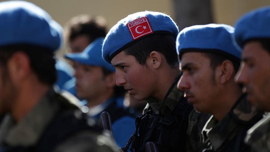 A member of the Free police, wearing a Turkish flag on his hat, attends a ceremony celebrating the inauguration of the "Free Police" in the Syrian border town of Jarablus January 24, 2017. REUTERS/Khalil Ashawi - RTSX6LE
