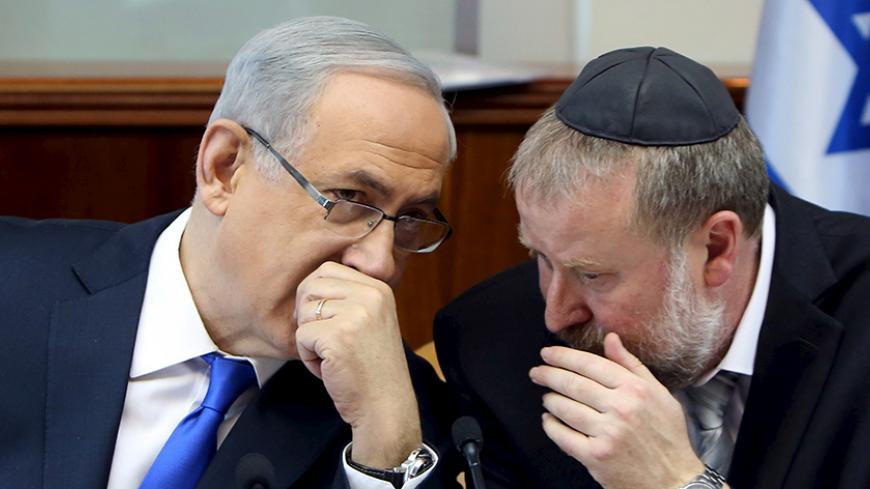Israeli Prime Minister Benjamin Netanyahu (L) speaks with Cabinet Secretary Avichai Mandelblit during the weekly cabinet meeting in Jerusalem December 20, 2015. REUTERS/Gali Tibbon/Pool - RTX1ZGHK
