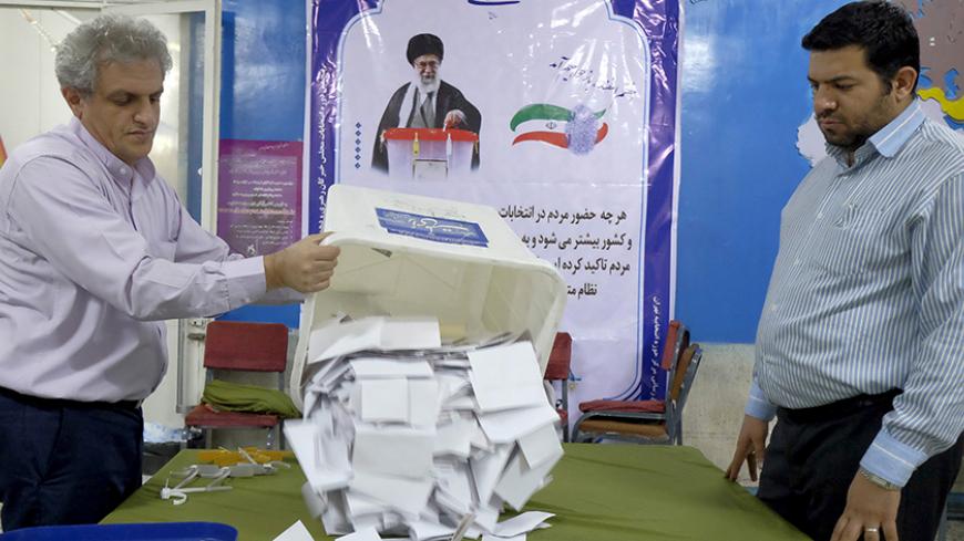 Election officials count ballot papers after the closure of polling stations during elections for the parliament and Assembly of Experts, which has the power to appoint and dismiss the supreme leader, in Tehran, Iran February 26, 2016. REUTERS/Raheb Homavandi/TIMA  ATTENTION EDITORS - THIS IMAGE WAS PROVIDED BY A THIRD PARTY. FOR EDITORIAL USE ONLY.       TPX IMAGES OF THE DAY      - RTX28SG1