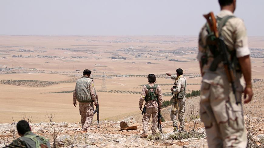 Fighters of the Manbij military council, allied to Syria Democratic Forces (SDF), take an overwatch position in the southern rural area of Manbij, in Aleppo Governorate, Syria June 1, 2016. REUTERS/Rodi Said/File Photo - RTX2ONCT