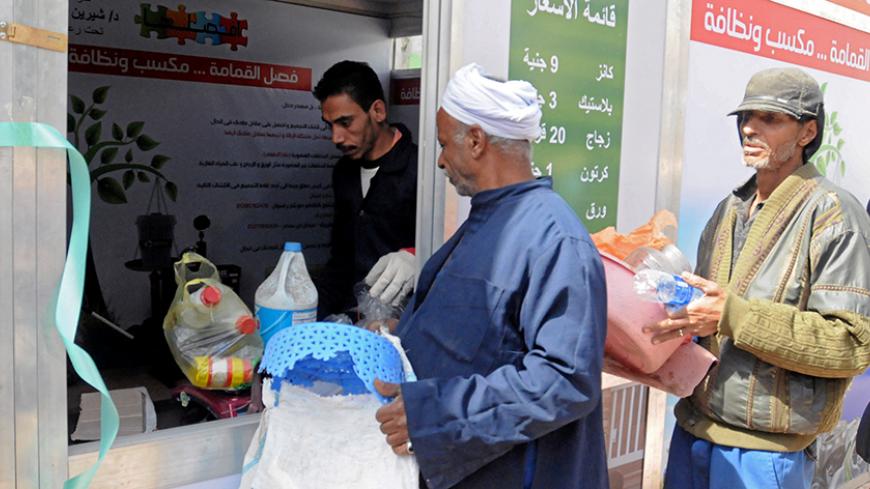 Men stand in line to sell their garbage at a centre that offers residents money in exchange of their recyclable garbage in an attempt to keep the city streets clean in Cairo, Egypt, March 11, 2017. Picture taken March 11, 2017. REUTERS/Foaad Shokry - RTX314ZC