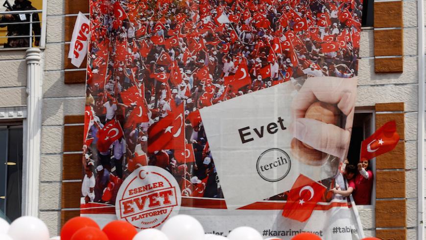 People wave national flags as they wait for arrival of Turkish President Tayyip Erdogan during a ceremony in Istanbul, Turkey, March 26, 2017. Picture taken March 26, 2017. REUTERS/Murad Sezer - RTX32WEA
