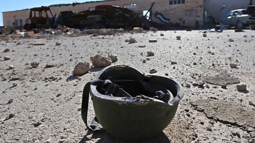 A helmet belonging to a Islamic State militant is seen on the ground at the 121 Regiment base after Fighters from the Democratic Forces of Syria took control of the base in the town of al-Melabiyyah, south of Hasaka city, Syria November 24, 2015. Picture taken November 24, 2015. REUTERS/Rodi Said  - RTX1VR2N