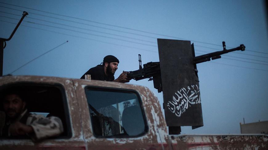 A member of the  Islamist Syrian opposition group Ahrar al-Sham fires against a position of the Committees for the Protection of the Kurdish People (YPG), a militia set up to protect Kurdish areas in Syria from opposing forces, during clashes in the countryside of the northern Syrian Raqqa province on August 25, 2013. Syrian Foreign Minister Walid Muallem said on August 27 the UN mission investigating alleged chemical weapons attacks in Damascus has been delayed until the following after rebels failed to gu