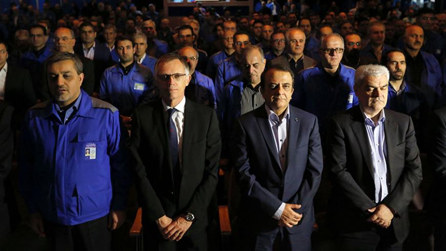 Hashem Yekkeh-Zareh, the CEO of industrial group Iran Khodro (2-R) and the head of French car manufacturing giant PSA group, Carlos Tavares (2-L), attend a press conference at the Iran Khodro Industrial Group showroom in the Iranian capital Tehran, on October 5, 2016. / AFP / ATTA KENARE        (Photo credit should read ATTA KENARE/AFP/Getty Images)