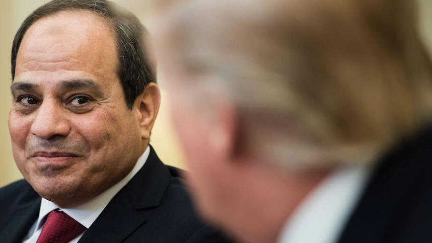 TOPSHOT - US President Donald Trump(R) listens while Egypt's President Abdel Fattah el-Sisi makes a statement to the press in the Oval Office before a meeting at the White House on April 3, 2017 in Washington, DC. / AFP PHOTO / Brendan Smialowski (Photo credit should read BRENDAN SMIALOWSKI/AFP/Getty Images)
