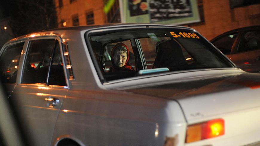 Iranian women talk in a taxi in the city of Isfahan, 400 kms south of Tehran on March 18, 2008 few days before the Persian new year, or Noruz, which starts on March 21. AFP PHOTO/FRED DUFOUR (Photo credit should read FRED DUFOUR/AFP/Getty Images)