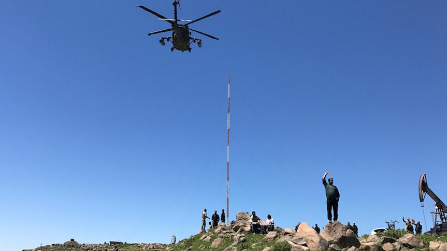 A helicopter carrying U.S. military officials arrive at the headquarters of the Kurdish fighters from the People's Protection Units (YPG) that was hit by Turkish airstrikes in Mount Karachok near Malikiya, Syria April 25, 2017. REUTERS/Rodi Said - RTS13T7T