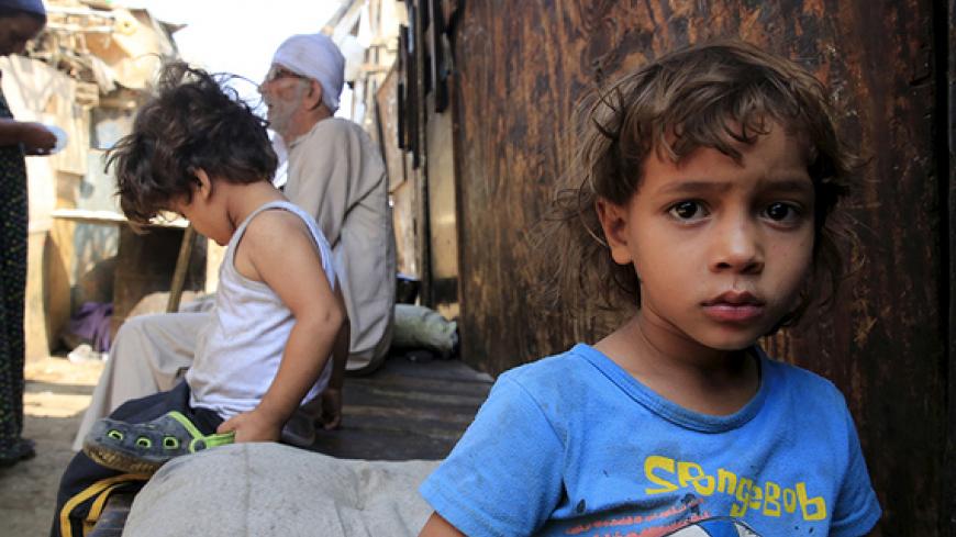 A boy stands in the Eshash El-Sudan slum in the Dokki neighbourhood of Giza, south of Cairo, Egypt, September 2, 2015. Residents of the slum clashed with police in late August, when about 50 ramshackle huts were destroyed and at least 20 people were injured by teargas, local media reported, as authorities attempt to clear the area and rehouse residents. The slum dwellers, some of whom have called Eshash el-Sudan home for 50 years, say there are not enough apartments built nearby to house them. The residents