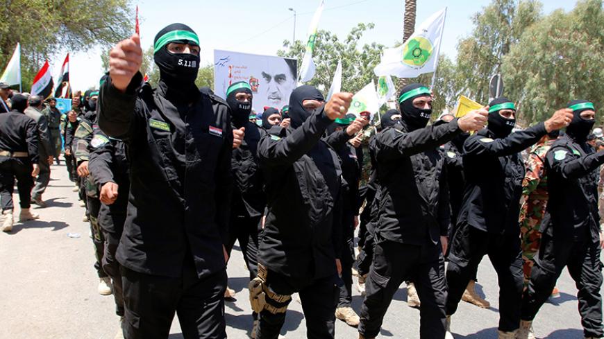 Iraqi Shi'ite Muslims from Hashid Shaabi (Popular Mobilization) march during a parade marking the annual al-Quds Day, or Jerusalem Day, during the Muslim holy month of Ramadan in Baghdad, Iraq July 1, 2016. REUTERS/Khalid al Mousily - RTX2J7WU