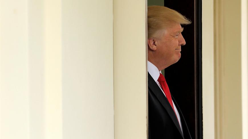 U.S. President Donald Trump waits to welcome Denmark's Prime Minister Lars Lokke Rasmussen at the White House in Washington, U.S. March 30, 2017.  REUTERS/Jonathan Ernst - RTX33FJG