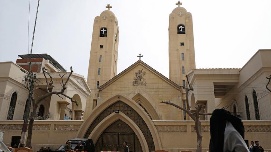 A woman passes in front of the Coptic church that was bombed on Sunday in Tanta, Egypt, April 10, 2017. REUTERS/Mohamed Abd El Ghany - RTX34XS0