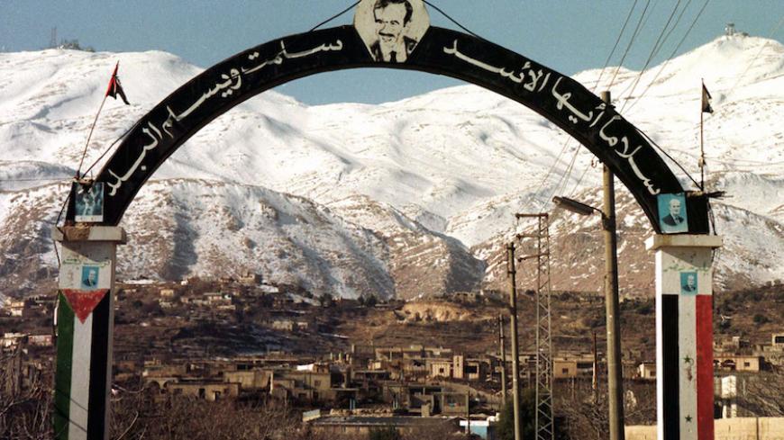 A portrait of Syrian President Hafez al-Assad on January 19 at the entrance of the village of Hadar in the Syrian side of Golan Heights close to Mount Haramoun which is a stratigic site that Israel occupied with Golan Heights in 1967.The Golan is at the centre of Syrian-Israeli peace negotiations. - RTXJG3W