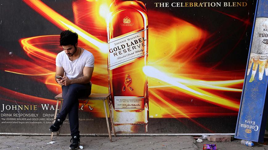An Iraqi man sits in front to a closed liquor store in Ainkawa, a majority Christian area in the Kurdish region of northern Iraq, on October 13, 2015.
 / AFP / SAFIN HAMED        (Photo credit should read SAFIN HAMED/AFP/Getty Images)