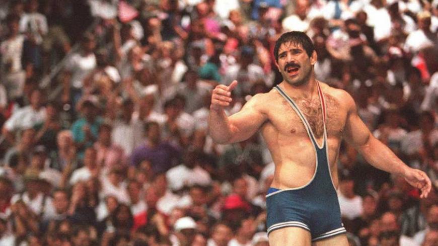 ATLANTA, GA - JULY 31:  Iran's Abbas Jadidi (R) reacts after being defeated by Kurt Angle (L) of the US in the final bout of the men's Olympic freestyle 100kg wrestling 31 July at the Georgia World Congress Center in Atlanta. Angle won gold on a 1-1 decision. (FOR EDITORIAL USE ONLY) AFP-IOPP/Georges GOBET  (Photo credit should read AFP-IOP/AFP/Getty Images)