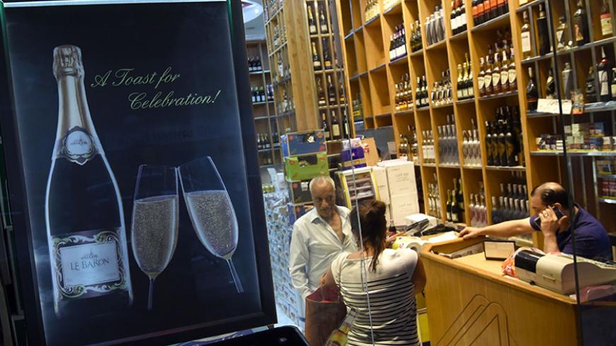 People shop at a liquor store in the Zamalek district of western Cairo on July 21, 2016
Since the early 2000s, Kouroum of the Nile and Domaine de Gianaclis -- the only two companies that produce wine in Egypt -- have launched an ambitious quest: to revive the country's wine production by importing grape varieties from France, Italy and also Spain -- Merlot, Syrah, Viognier and Vermentino. / AFP / MOHAMED EL-SHAHED / TO GO WITH AFP STORY BY TONY GAMAL-GABRIEL (Photo credit should read MOHAMED EL-SHAHE