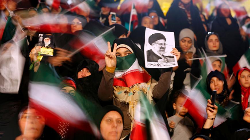 TOPSHOT - Supporters of Iranian presidential candidate Ebrahim Raisi attend a campaign rally in the capital Tehran on April 29, 2017. / AFP PHOTO / ATTA KENARE        (Photo credit should read ATTA KENARE/AFP/Getty Images)