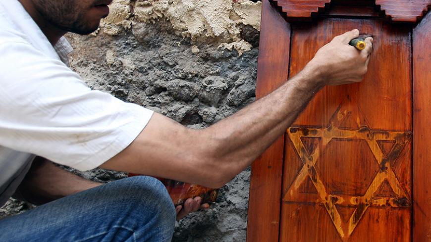 An Egyptian worker carries out restoration work at Moses Maimonides Temple, the first Jewish temple to be built in Egypt during the 19th Century, in Cairo August 20, 2009, Dr. Zahi Hawas, the Secretary General of the Higher Antiquities Authority inspected the restoration project of the temple on Thursday, Moses Maimonides, also known as Rabbi Moshe ben Maimon, or the acronym the Rambam, was born in Cordoba, Spain on March 30, 1135, and died in Egypt on December 13, 1204 and was a doctor of the al-Sultan Sal