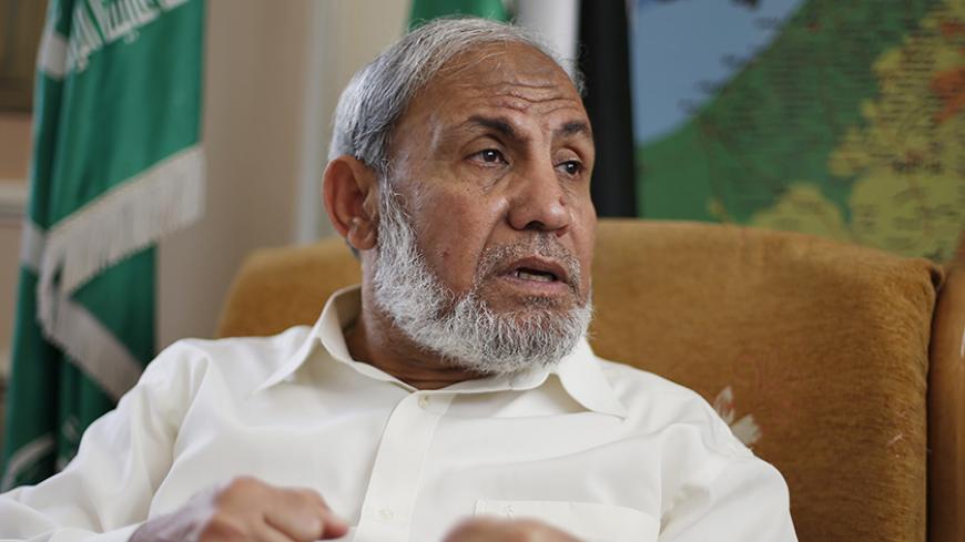 Veteran Hamas strategist Mahmoud Al-Zahar gestures during an interview with Reuters at his house in Gaza City April 29, 2014. A Palestinian unity deal will not lead Islamist group Hamas to recognise Israel's right to exist and will not result in any Gaza militants coming under President Mahmoud Abbas's control, Al-Zahar said on Tuesday. To match Interview PALESTINIAN-ISRAEL/HAMAS  REUTERS/Suhaib Salem (GAZA - Tags: POLITICS) - RTR3N3DL