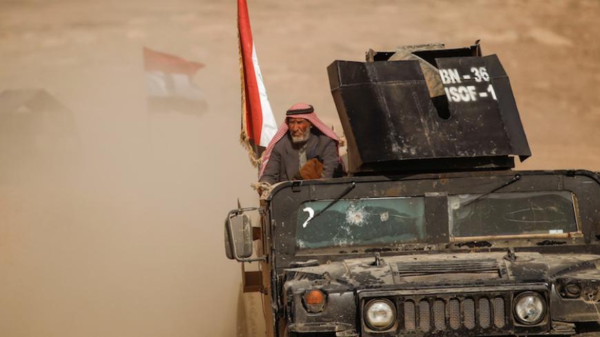 A displaced elderly Iraqi  man who just fled his home arrives on military humvee at Sepcial forces base , as Iraqi forces battle with Islamic State militants, in western Mosul, Iraq February 27, 2017. REUTERS/Zohra Bensemra - RTS10M3H