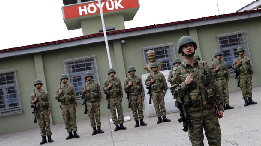 Turkish soldiers stand at attention at Hoyuk military post on the border between Turkey and Syria near the southeastern city of Kilis, Turkey, March 2, 2017. REUTERS/Murad Sezer - RTS114DJ