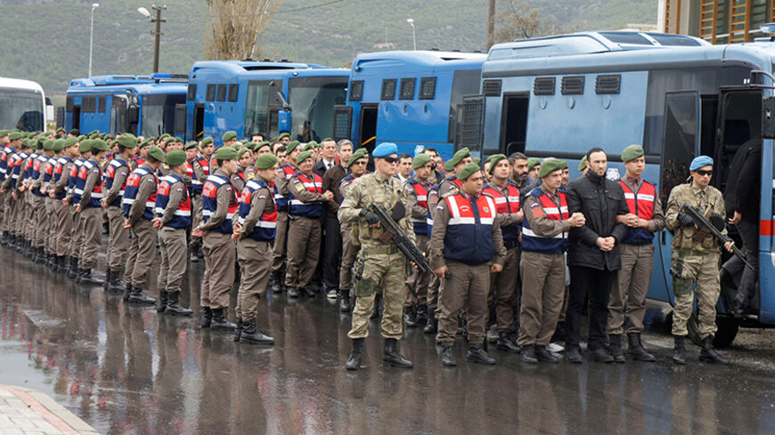 Turkish soldiers accused of attempting to assassinate President Tayyip Erdogan on the night of the failed July 15 coup, are escorted by gendarmes as they arrive at the court in Mugla, Turkey, March 8, 2017. REUTERS/Kenan Gurbuz - RTS11XPE