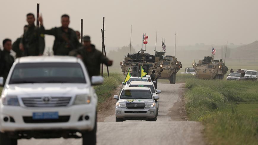 Kurdish fighters from the People's Protection Units (YPG) head a convoy of U.S military vehicles in the town of Darbasiya next to the Turkish border, Syria April 28, 2017. REUTERS/Rodi Said - RTS14EFX