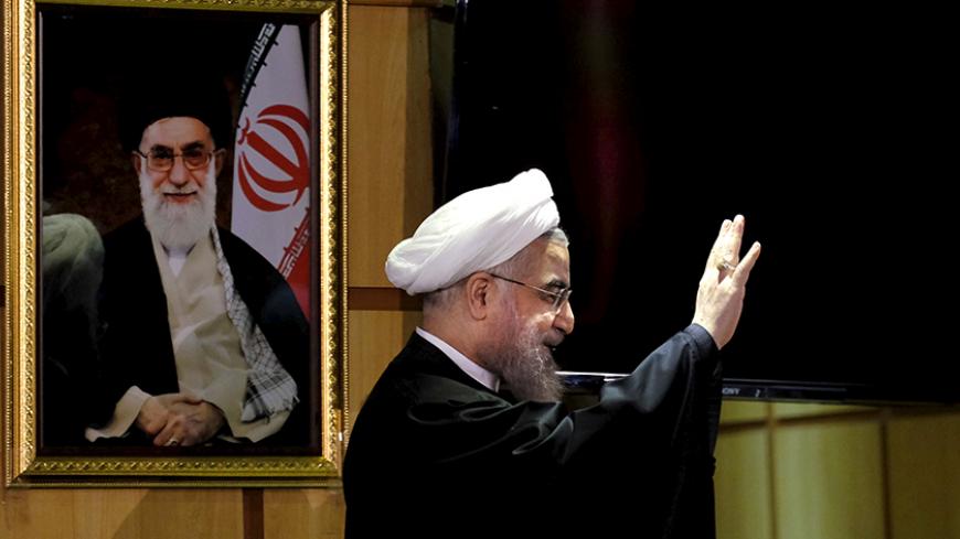 Iranian President Hassan Rouhani waves as he stands next to a portrait of Iran's Supreme Leader Ayatollah Ali Khamenei, after he registered for February's election of the Assembly of Experts, the clerical body that chooses the supreme leader, at Interior Ministry in Tehran December 21, 2015. REUTERS/Raheb Homavandi/TIMA ATTENTION EDITORS - THIS IMAGE WAS PROVIDED BY A THIRD PARTY. FOR EDITORIAL USE ONLY. TPX IMAGES OF THE DAY     - RTX1ZKHQ
