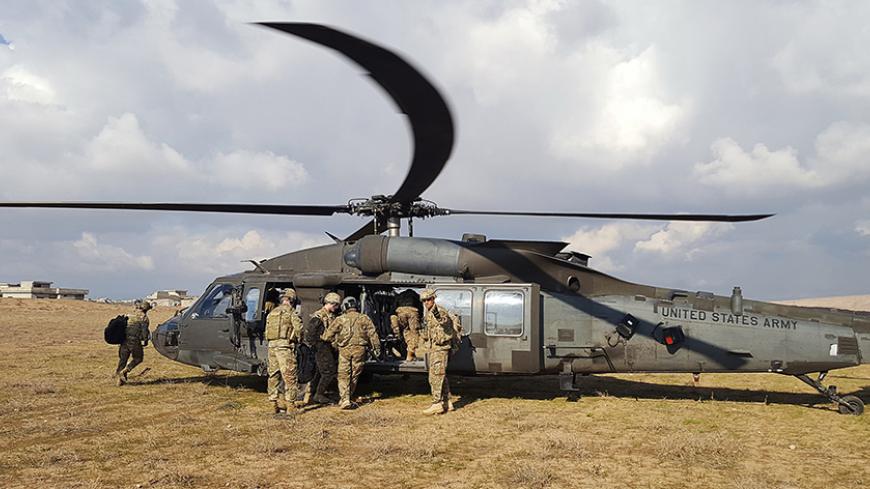 U.S. soldiers ride in a helicopter at a military base north of Mosul, Iraq, January 4, 2017. REUTERS/Stephen Kalin - RTX2XK7T