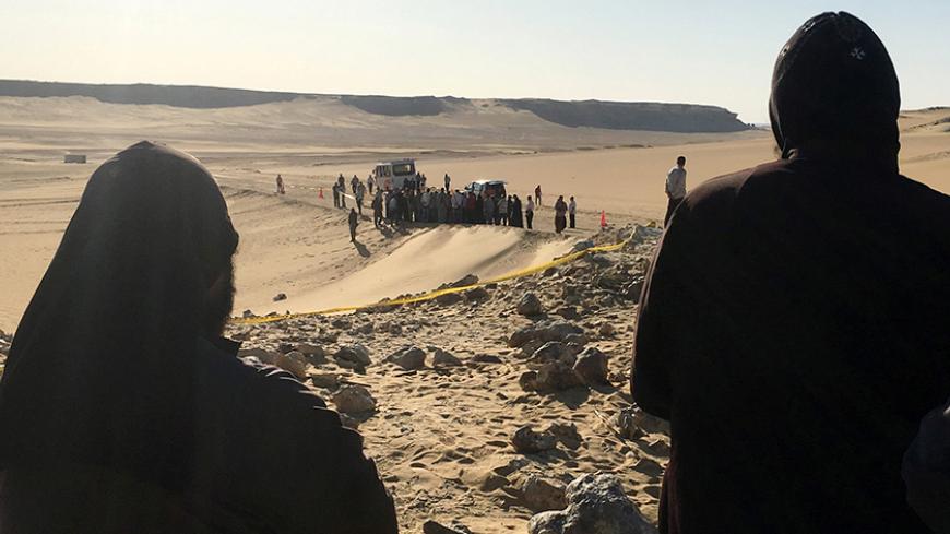Monks look at the view following a gunmen attack against a group of Coptic Christians travelling to a monastery in southern Egypt, in Minya, May 26, 2017. REUTERS/Mohamed Abd El Ghany - RTX37S37