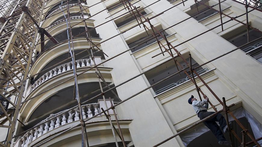 An employee works at a residential building, currently under construction, in northern Tehran May 17, 2008. Negar Ehteshami just paid the equivalent of $6 million in rials in cash for a luxurious apartment. But it is not in New York or London. It is in the capital of the Islamic Republic of Iran. Hers is a tale with echoes in much of the West: a house price surge fuelled partly by easy lending. Picture taken May 17, 2008.  To match feature IRAN-HOUSING/  REUTERS/Morteza Nikoubazl (IRAN) - RTX68C7