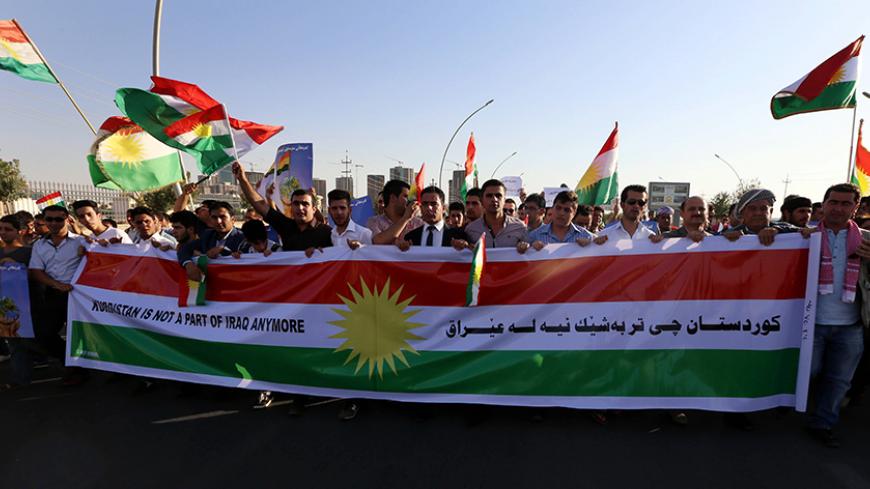 Iraqi Kurdish demonstrators wave the Kurdish flag during a protest demanding for the independence of Kurdistan outside the United Nations offices in Arbil, the capital of the autonomous Kurdish region, on August 23, 2014. About 700,000 Iraqis have gathered in the Kurdish north after being driven from their homes by jihadist Islamic State (IS) fighters, the UN said as it stepped up a massive aid operation to the region. AFP PHOTO / SAFIN HAMED (Photo credit should read SAFIN HAMED/AFP/Getty Images)