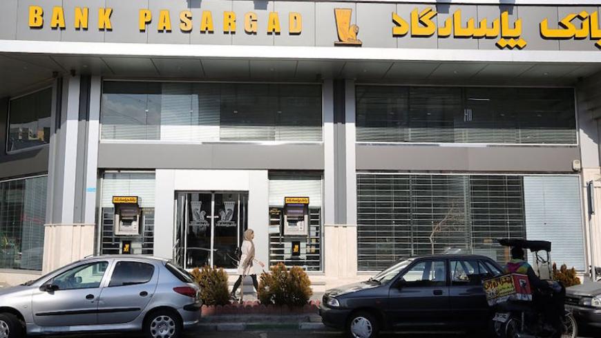 An Iranian woman walks past a Bank Pasargad in the capital Tehran on January 19, 2016.
Iran will receive $32 billion of unfrozen assets after sanctions were lifted in a deal with world powers over its nuclear programme, Iranian central bank chief Valiollah Seif said. / AFP / ATTA KENARE        (Photo credit should read ATTA KENARE/AFP/Getty Images)