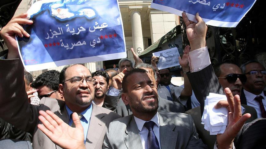 Protesters shout slogans and hold a banner that reads in Arabic 'two Red Sea islands are Egyptian', against a deal that sees Egypt cede sovereignty over two Red Sea islands to Saudi Arabia currently being debated in parliament in downtown Cairo, Egypt June 13, 2017. REUTERS/Mohamed Abd El Ghany - RTS16WQH