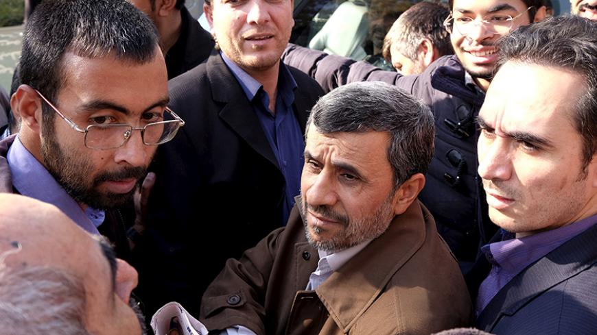 Former Iranian President Mahmoud Ahmadinejad (C front) listens to his supporters during the funeral ceremony of Iran's Ambassador to Lebanon Ghazanfar Roknabadi, who was killed in Saudi Arabia in a stampede at the haj pilgrimage, after Friday prayer in Tehran November 27, 2015. REUTERS/Raheb Homavandi/TIMA ATTENTION EDITORS - THIS IMAGE WAS PROVIDED BY A THIRD PARTY. FOR EDITORIAL USE ONLY. - RTX1W3E5