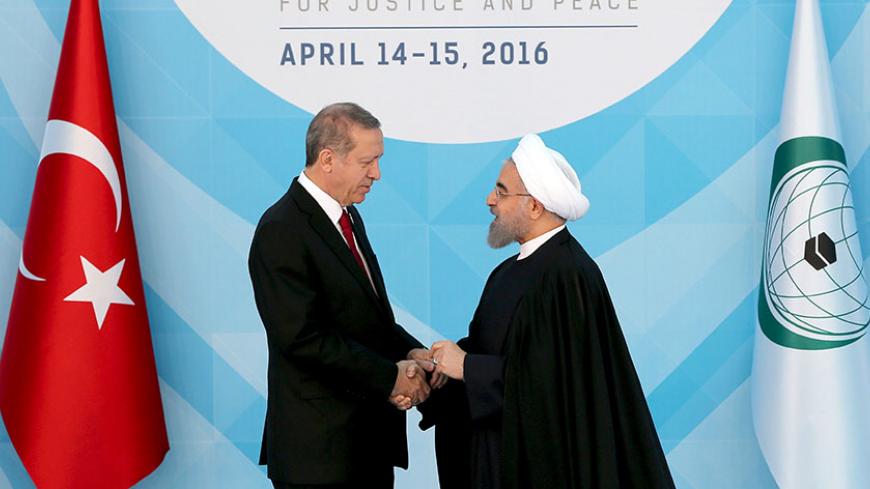 Turkish President Tayyip Erdogan (L) welcomes his Iranian counterpart Hassan Rouhani during the Organisation of Islamic Cooperation (OIC) Istanbul Summit in Istanbul, Turkey April 14, 2016. REUTERS/Berk Ozkan/Pool      TPX IMAGES OF THE DAY      - RTX29X07