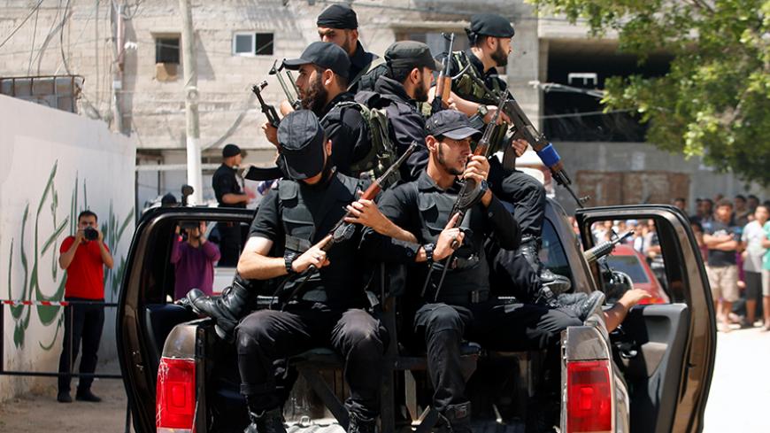 Members of Palestinian security forces loyal to Hamas ride a truck outside a Hamas-run military court where alleged collaborators with Israel are prosecuted, in Gaza City May 21, 2017. REUTERS/Mohammed Salem       TPX IMAGES OF THE DAY - RTX36SVG